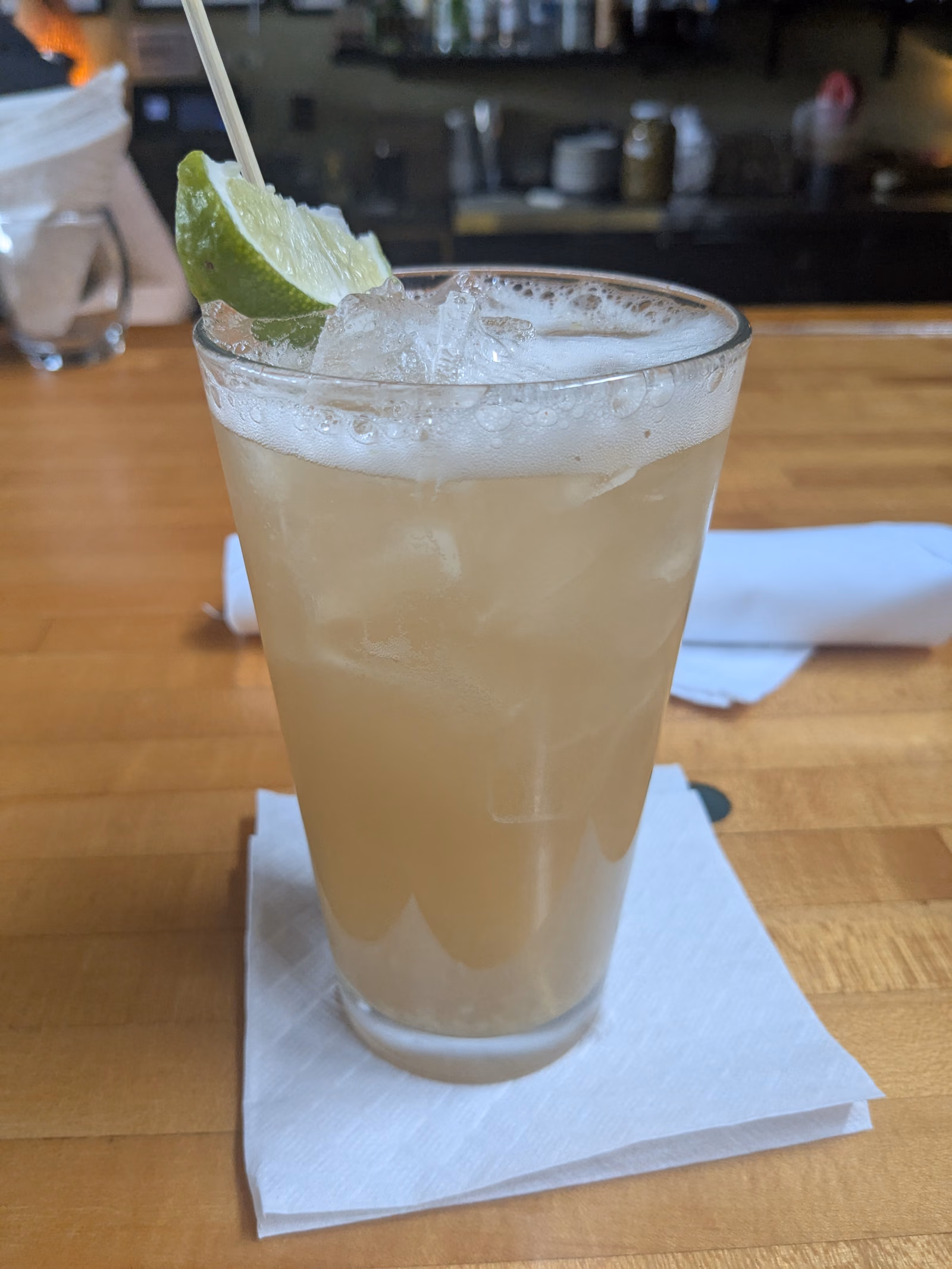 A tall glass of cloudy pale sorghum beer, freshly poured.